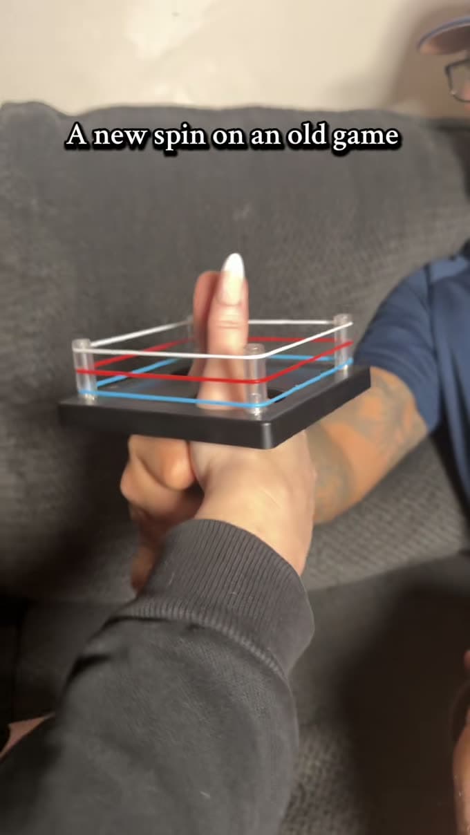 Thumb wrestling ring game